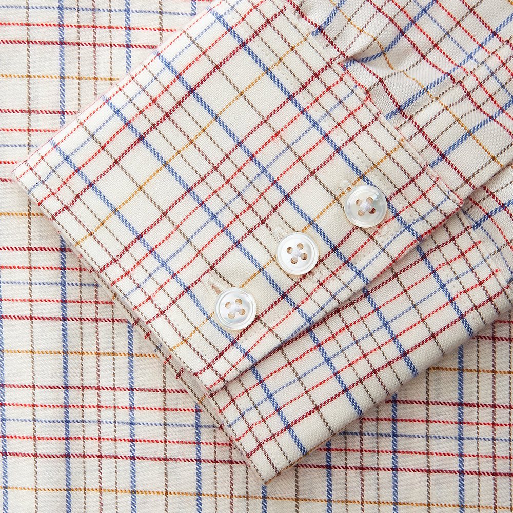 The Turnbull & Asser Red Multi Check Regular Fit Cotton-Cashmere Shirt features a T&A collar, 3 button cuffs, and a multicolored check pattern on white, shown laid flat against a white surface.