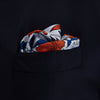 View 2 of product The Blue and Red Foliage Pattern Silk Pocket Square by Turnbull & Asser features intricate symmetrical leaves and flowers in red, blue, and navy on a light grey silk background, creating an elegant circular motif.