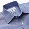 View 3 of product The Turnbull & Asser Blue Chambray Cotton Regular Fit Mayfair Shirt features a subtle textured pattern, pointed T&A collar, and white buttons. Shown here in a light blue shade, laid flat on a white background.