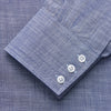 View 2 of product The Turnbull & Asser Blue Chambray Cotton Regular Fit Mayfair Shirt features a subtle textured pattern, pointed T&A collar, and white buttons. Shown here in a light blue shade, laid flat on a white background.