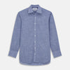 View 1 of product The Turnbull & Asser Blue Chambray Cotton Regular Fit Mayfair Shirt features a subtle textured pattern, pointed T&A collar, and white buttons. Shown here in a light blue shade, laid flat on a white background.