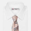 View 3 of product The Turnbull & Asser Pink Graphic Deco Silk Tie features blue geometric and square patterns on pale pink silk, shown rolled with the pointed end facing forward.
