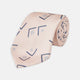The Turnbull & Asser Pink Graphic Deco Silk Tie features blue geometric and square patterns on pale pink silk, shown rolled with the pointed end facing forward.