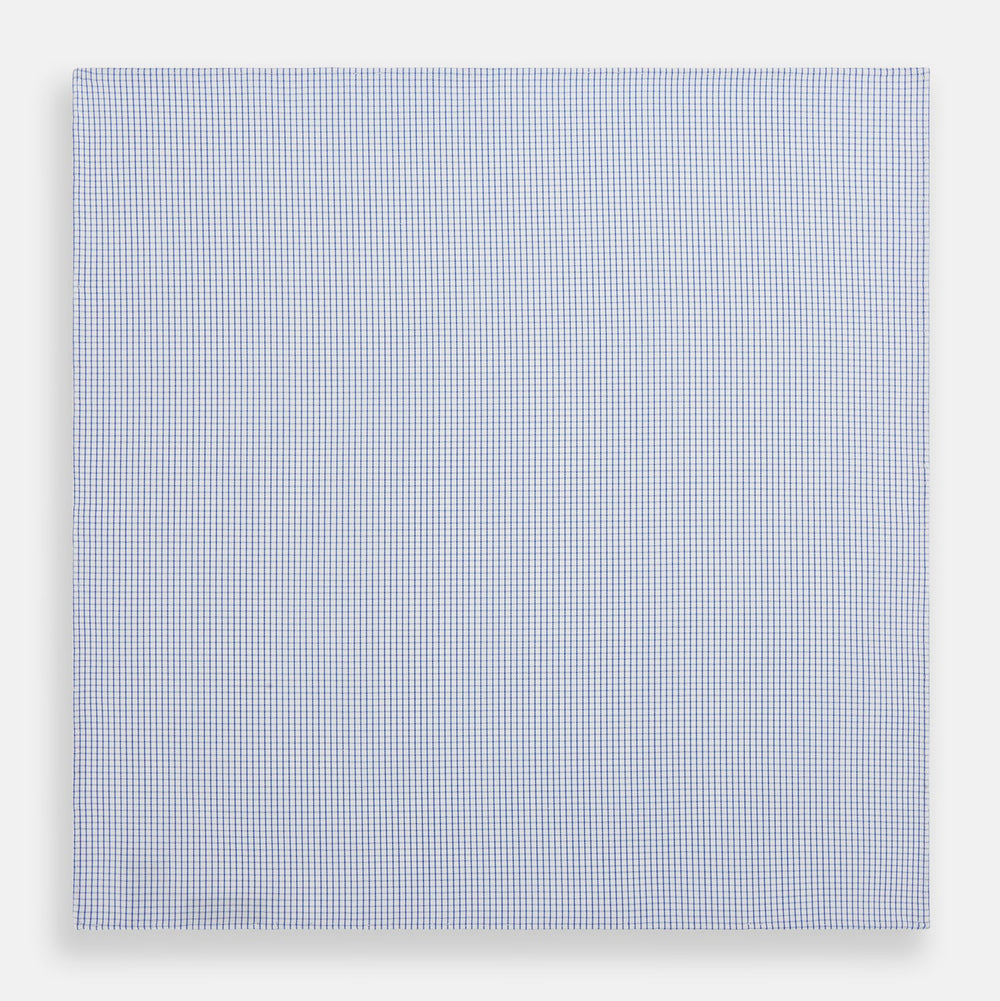 The Turnbull & Asser Hand Rolled Blue Graph Check Handkerchief features a white background with small blue checks—a refined, formal accessory for any occasion.