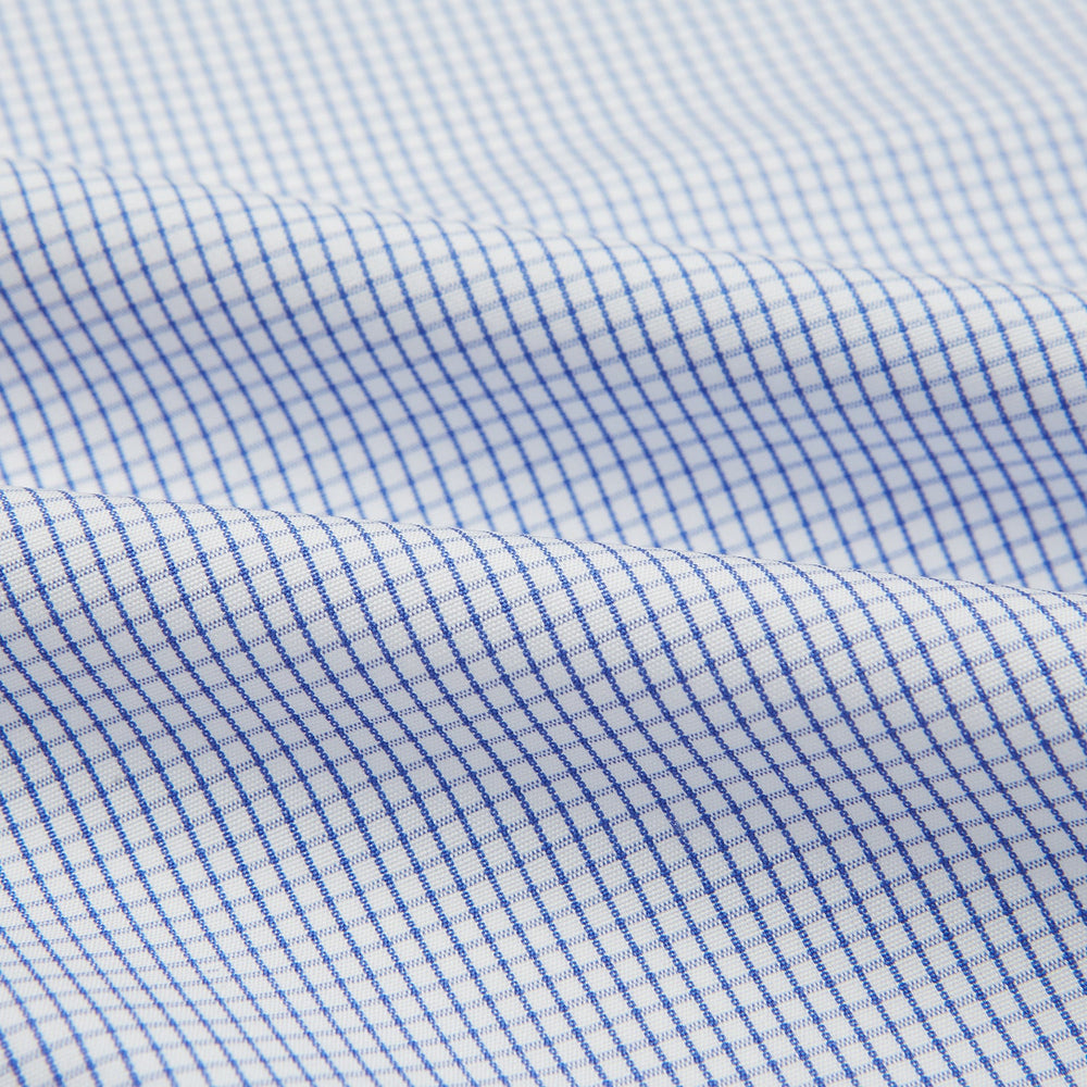 The Turnbull & Asser Hand Rolled Blue Graph Check Handkerchief features a white background with small blue checks—a refined, formal accessory for any occasion.