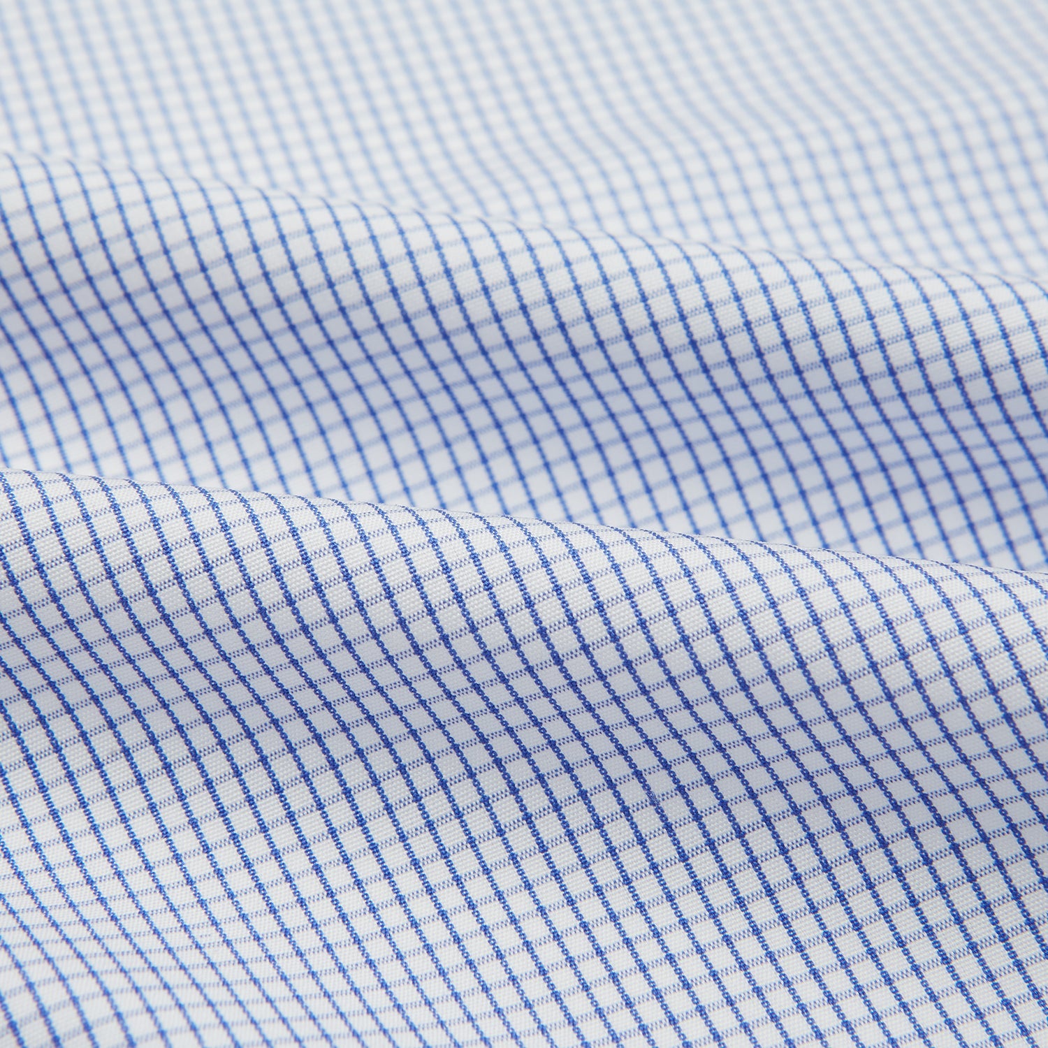 View 4 of product The Turnbull & Asser Hand Rolled Blue Graph Check Handkerchief features a white background with small blue checks—a refined, formal accessory for any occasion.