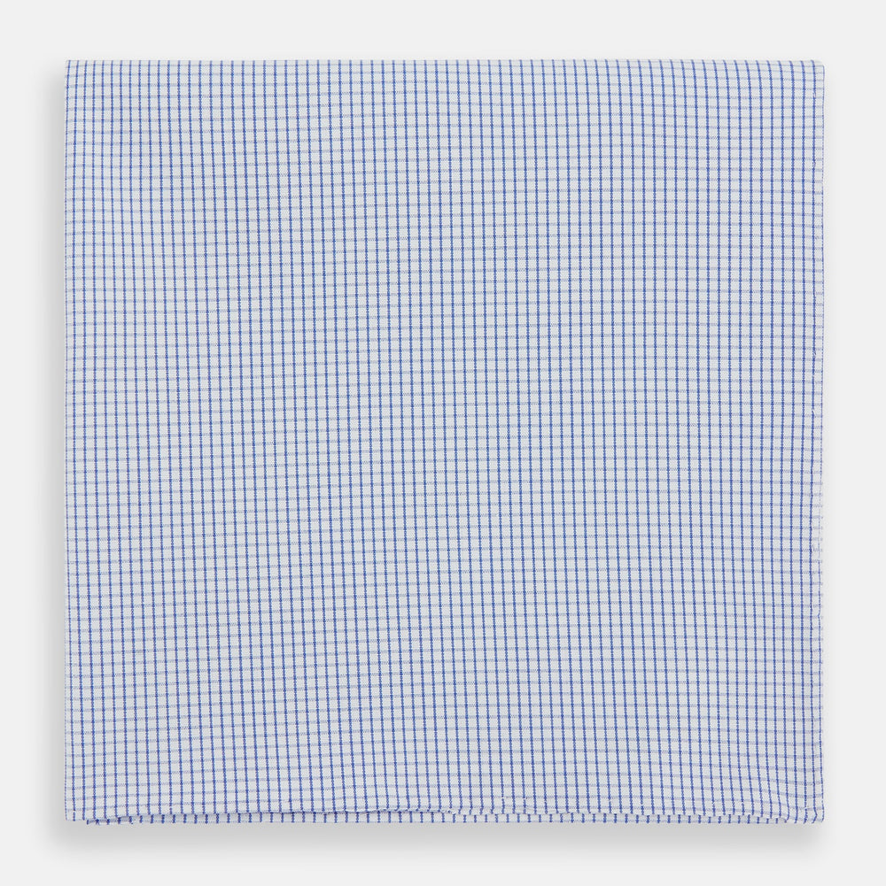 The Turnbull & Asser Hand Rolled Blue Graph Check Handkerchief features a white background with small blue checks—a refined, formal accessory for any occasion.