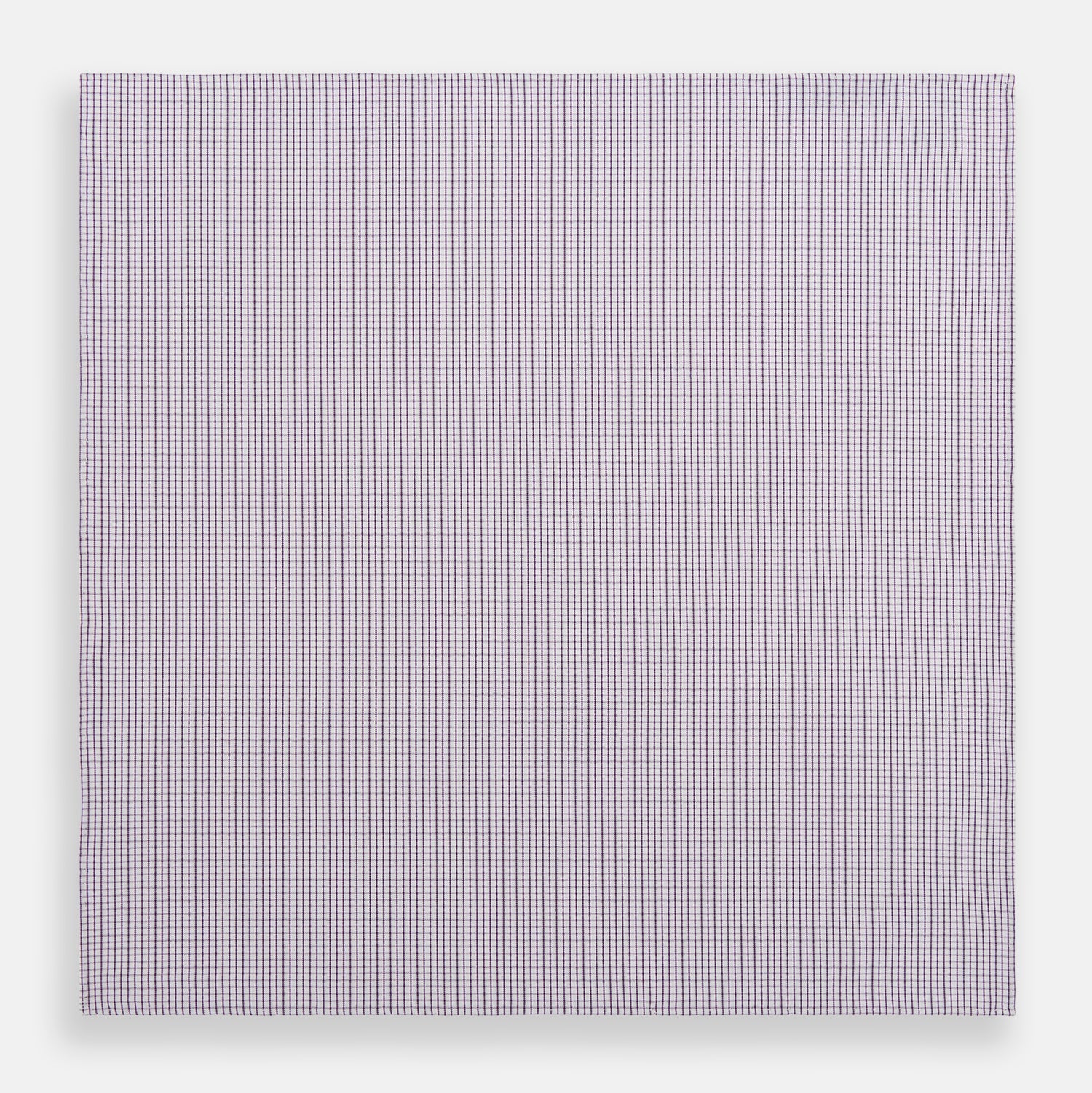 View 3 of product The Turnbull & Asser Hand Rolled Purple Graph Check Handkerchief features a purple checkered grid pattern on white cotton, neatly folded and displayed on a plain surface—a refined accessory for any formal occasion.