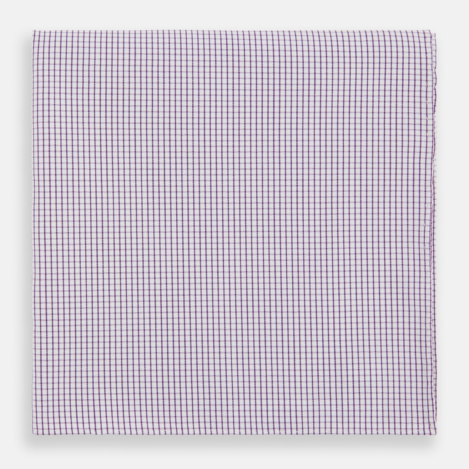View 1 of product The Turnbull & Asser Hand Rolled Purple Graph Check Handkerchief features a purple checkered grid pattern on white cotton, neatly folded and displayed on a plain surface—a refined accessory for any formal occasion.