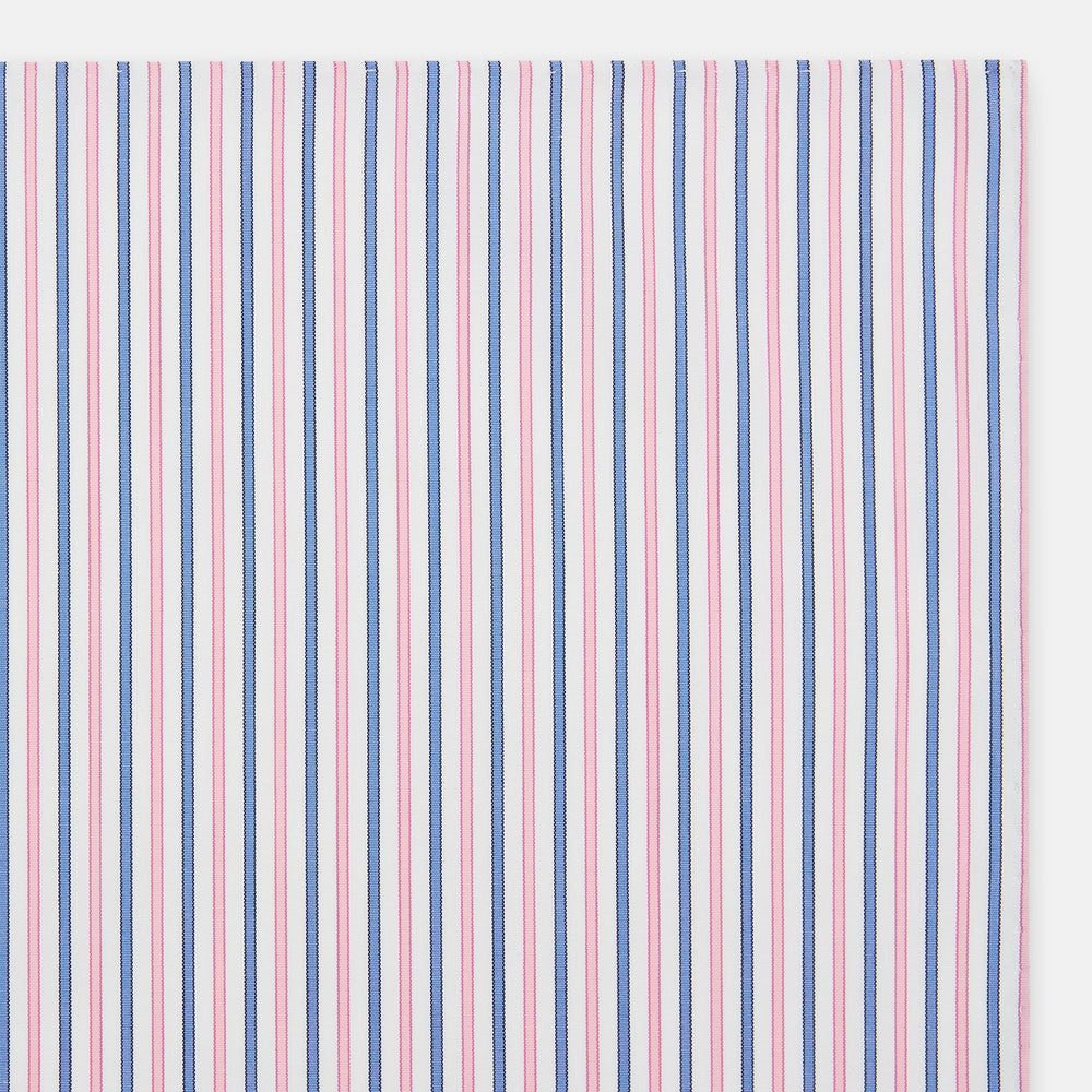 The Turnbull & Asser Hand Rolled Pink and Blue Track Stripe Handkerchief is a cotton square with blue, pink, and purple stripes on white, finished with a hand-rolled pink edge—an elegant addition to formal attire.