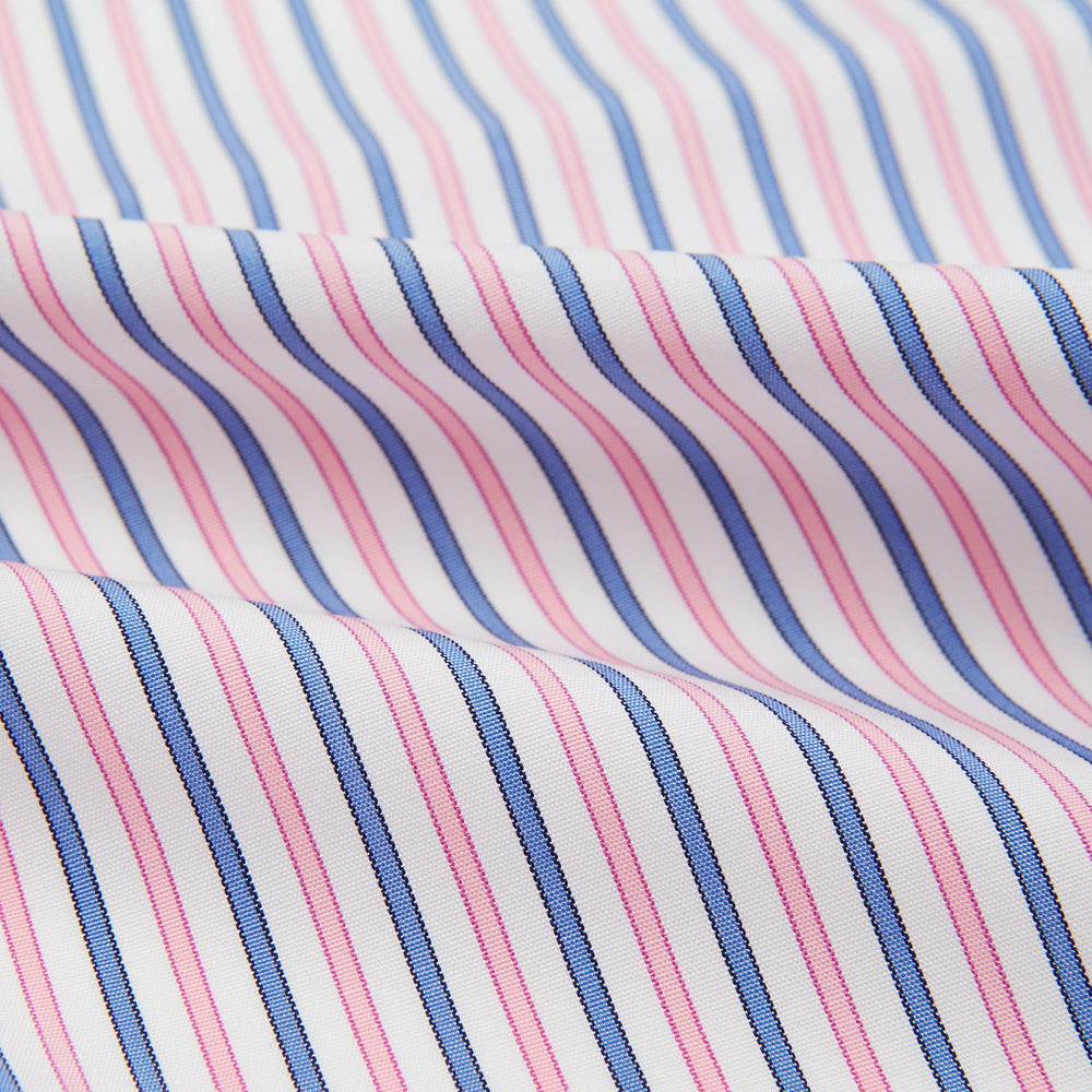 The Turnbull & Asser Hand Rolled Pink and Blue Track Stripe Handkerchief is a cotton square with blue, pink, and purple stripes on white, finished with a hand-rolled pink edge—an elegant addition to formal attire.