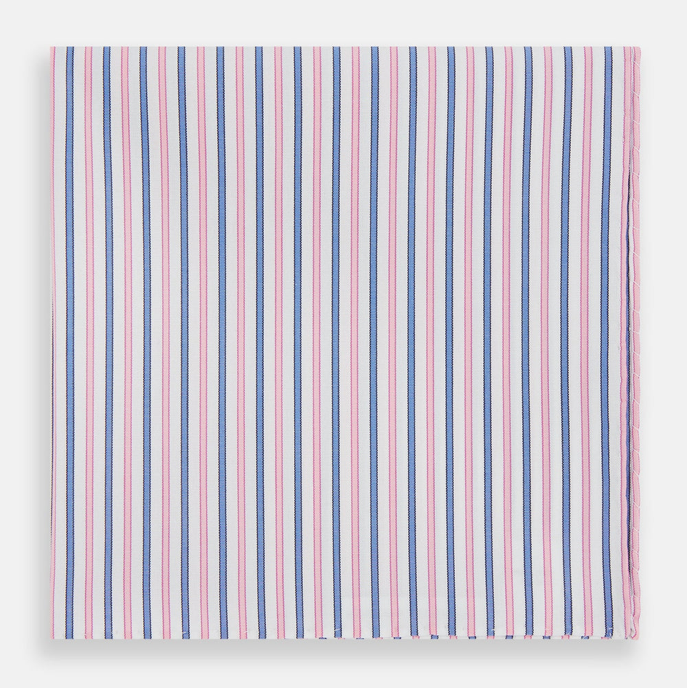 The Turnbull & Asser Hand Rolled Pink and Blue Track Stripe Handkerchief is a cotton square with blue, pink, and purple stripes on white, finished with a hand-rolled pink edge—an elegant addition to formal attire.