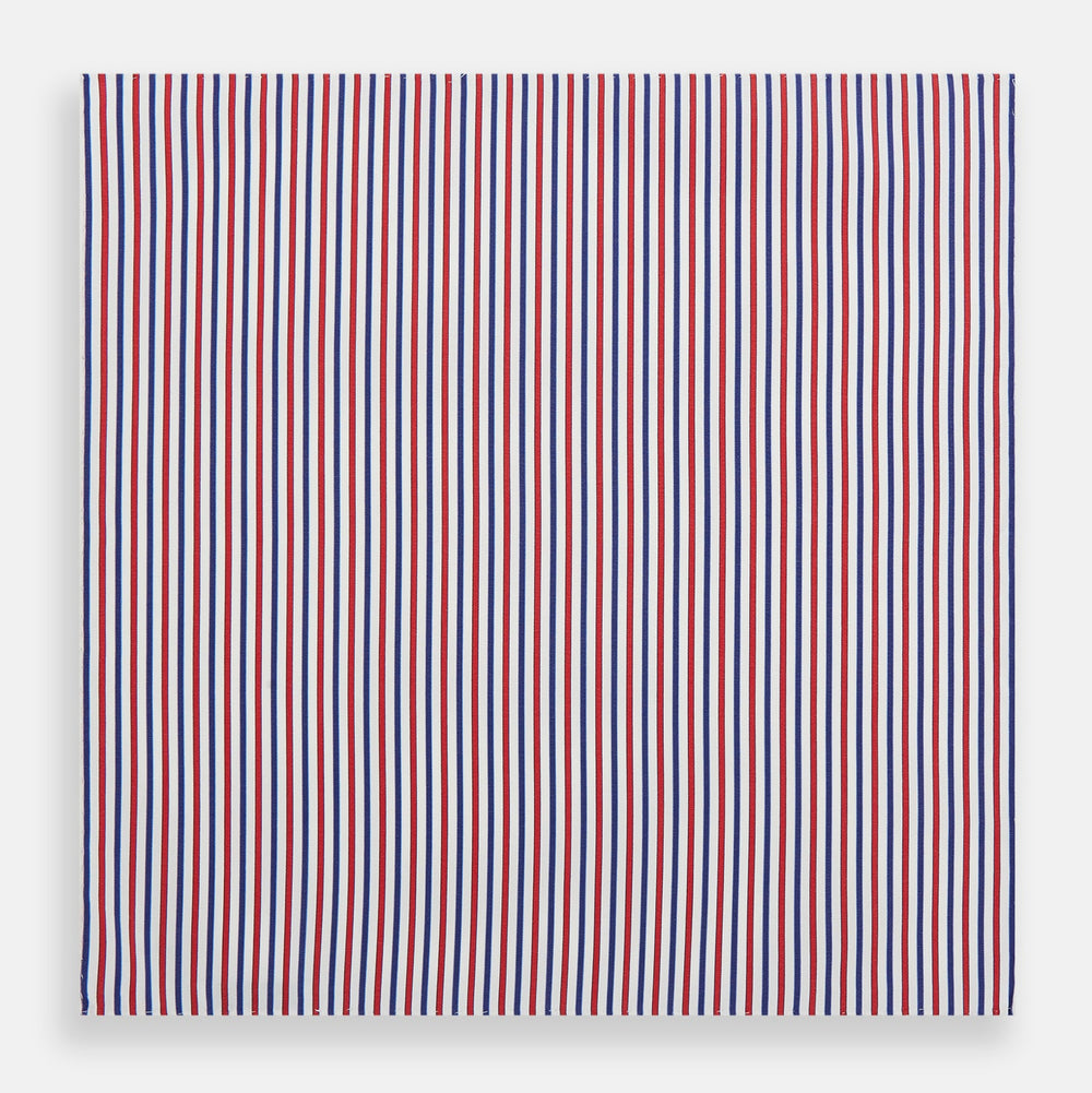 The Hand Rolled Red and Blue Track Stripe Handkerchief by Turnbull & Asser features vertical red, blue, and white stripes—a refined cotton accessory with a visible seam, ideal for formal occasions.
