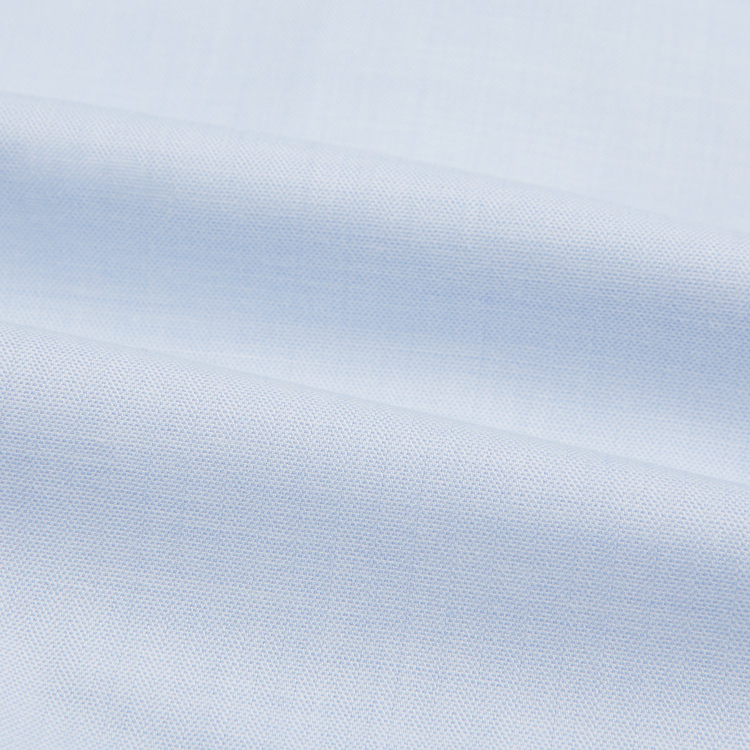 View 5 of product The Turnbull & Asser Blue Cashmerello Mayfair Shirt is a light blue cotton-cashmere blend with long sleeves, pointed collar, white buttons, and buttoned cuffs, shown on a plain white background.