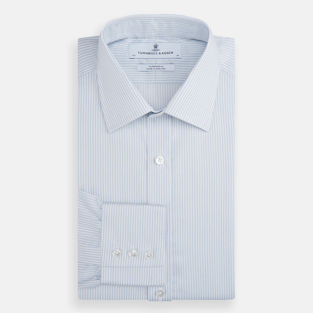 The Turnbull & Asser Blue and White Pencil Stripe Cashmerello Mayfair Shirt features a pointed collar, white buttons, buttoned cuffs, and long sleeves. Crafted from a cotton-cashmere blend, it’s displayed flat on a white background.