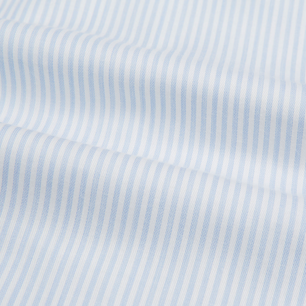 The Turnbull & Asser Blue and White Pencil Stripe Cashmerello Mayfair Shirt features a pointed collar, white buttons, buttoned cuffs, and long sleeves. Crafted from a cotton-cashmere blend, it’s displayed flat on a white background.
