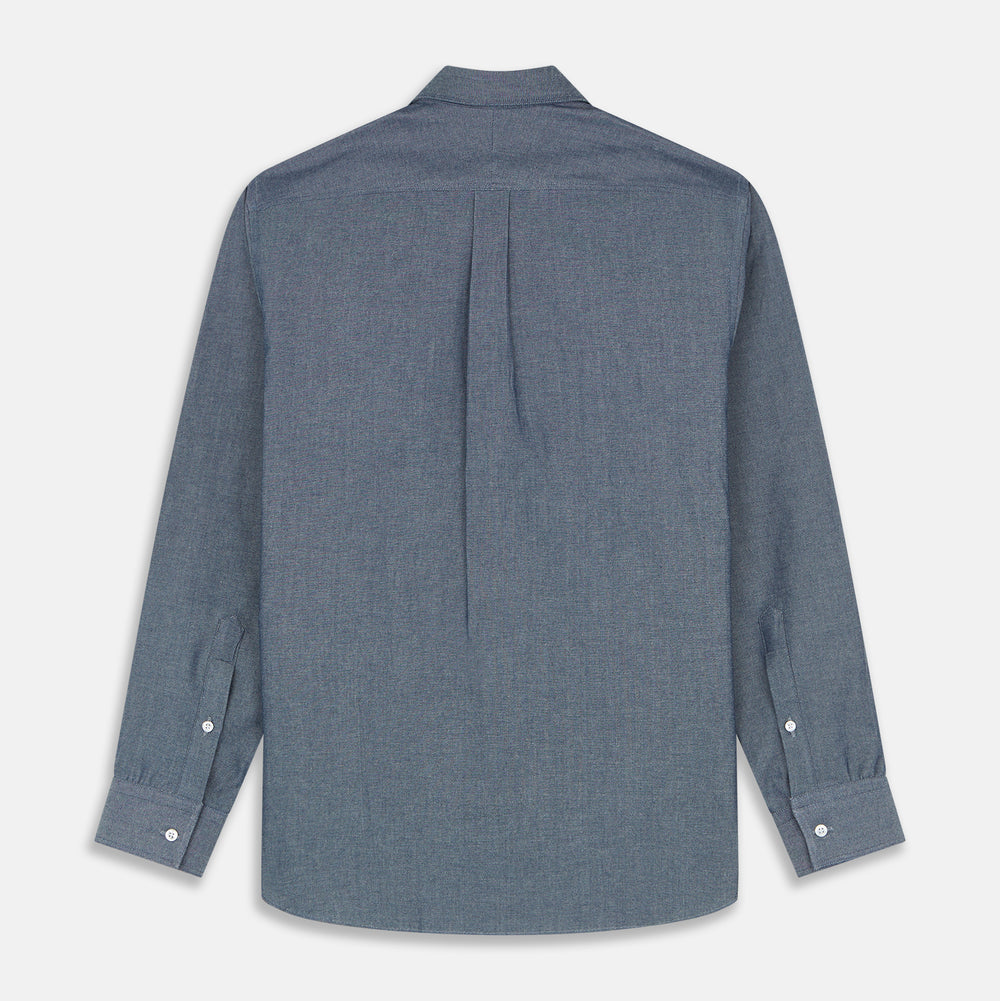 The Turnbull & Asser Blue Chambray Weekend Fit Nevis Cotton Shirt features a Dorset collar, 1-button cuffs, and smart-casual tailoring, shown laid flat on a white background.