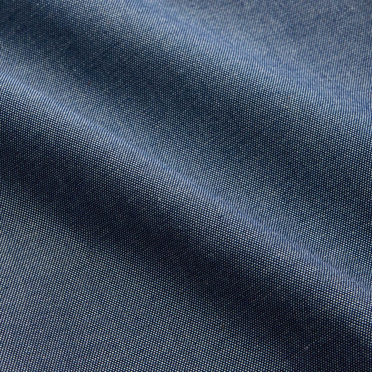 View 4 of product The Turnbull & Asser Blue Chambray Weekend Fit Nevis Cotton Shirt features a Dorset collar, 1-button cuffs, and smart-casual tailoring, shown laid flat on a white background.