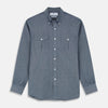 View 1 of product The Turnbull & Asser Blue Chambray Weekend Fit Nevis Cotton Shirt features a Dorset collar, 1-button cuffs, and smart-casual tailoring, shown laid flat on a white background.