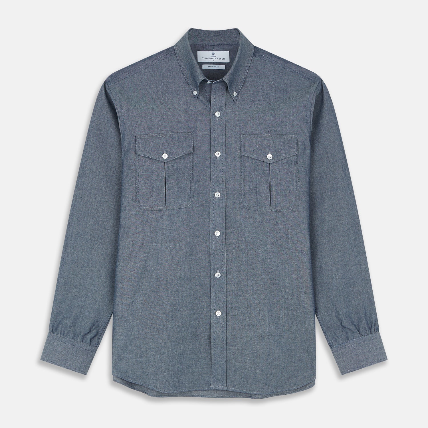 View 1 of product The Turnbull & Asser Blue Chambray Weekend Fit Nevis Cotton Shirt features a Dorset collar, 1-button cuffs, and smart-casual tailoring, shown laid flat on a white background.