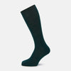 View 1 of product A single Turnbull & Asser Petrol Green Mid-Length Merino Sock stands upright on a plain white background, showcasing its ribbed texture and signature rounded toe and heel.