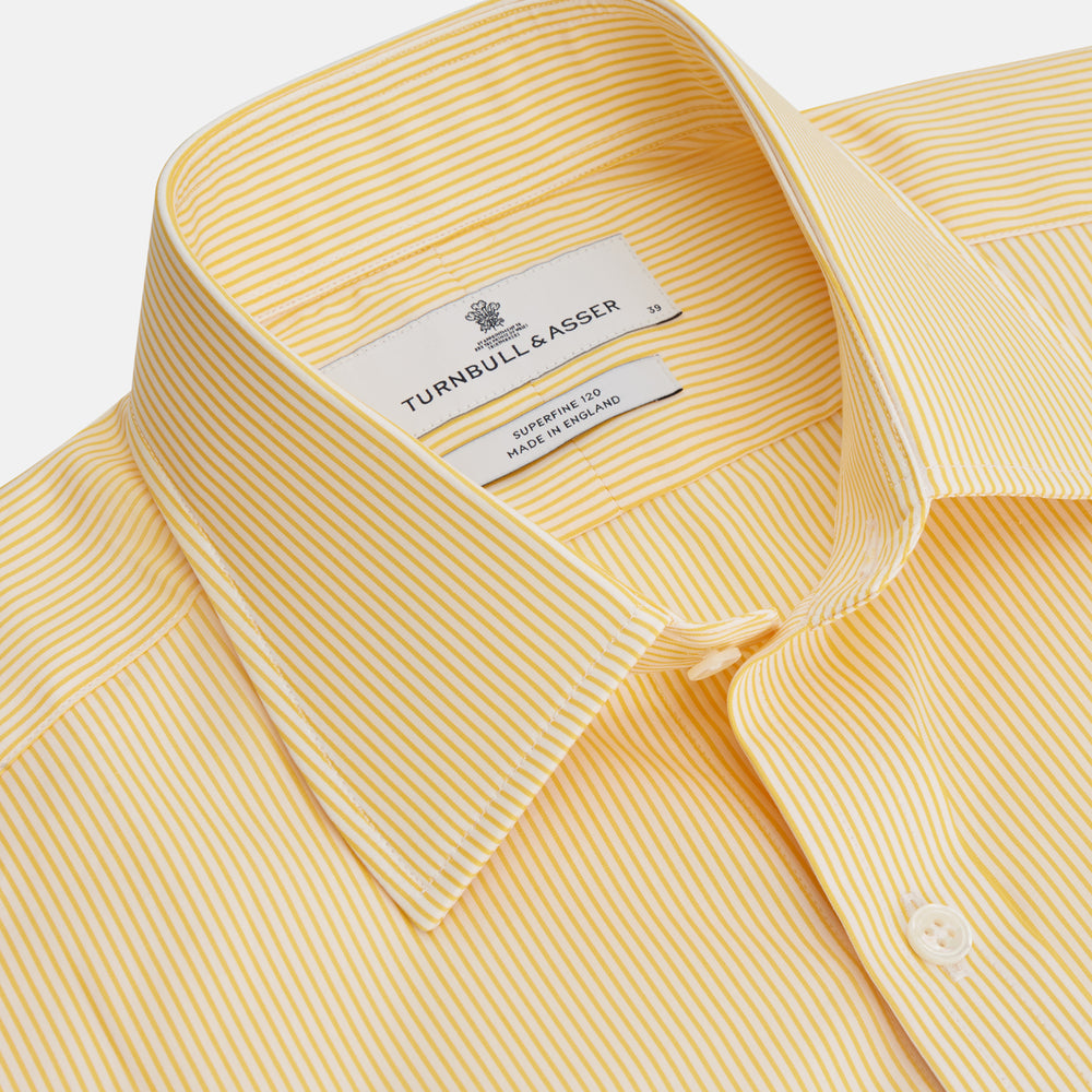 The Turnbull & Asser Yellow Fine Stripe Regular Fit Shirt with T&A Collar features long sleeves, a button-down front, and buttoned cuffs, crafted from fine Italian cotton and shown against a white background.