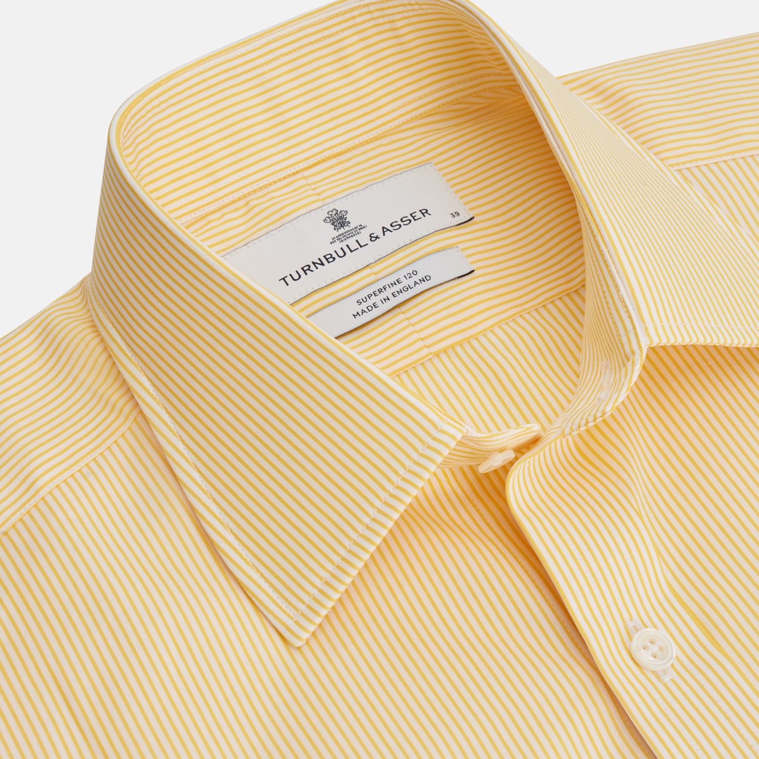 View 2 of product The Turnbull & Asser Yellow Fine Stripe Regular Fit Shirt with T&A Collar features long sleeves, a button-down front, and buttoned cuffs, crafted from fine Italian cotton and shown against a white background.