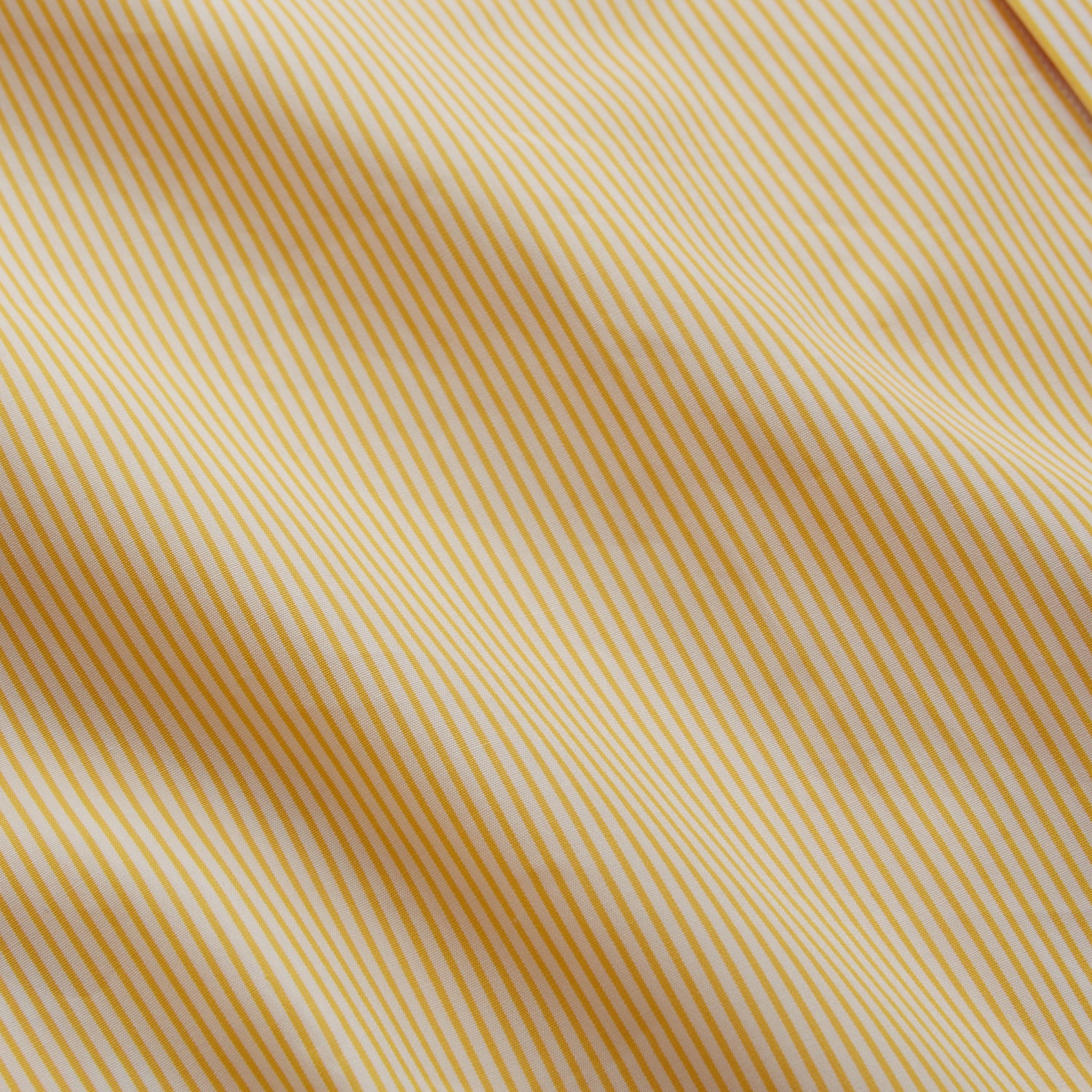 View 4 of product The Turnbull & Asser Yellow Fine Stripe Regular Fit Shirt with T&A Collar features long sleeves, a button-down front, and buttoned cuffs, crafted from fine Italian cotton and shown against a white background.