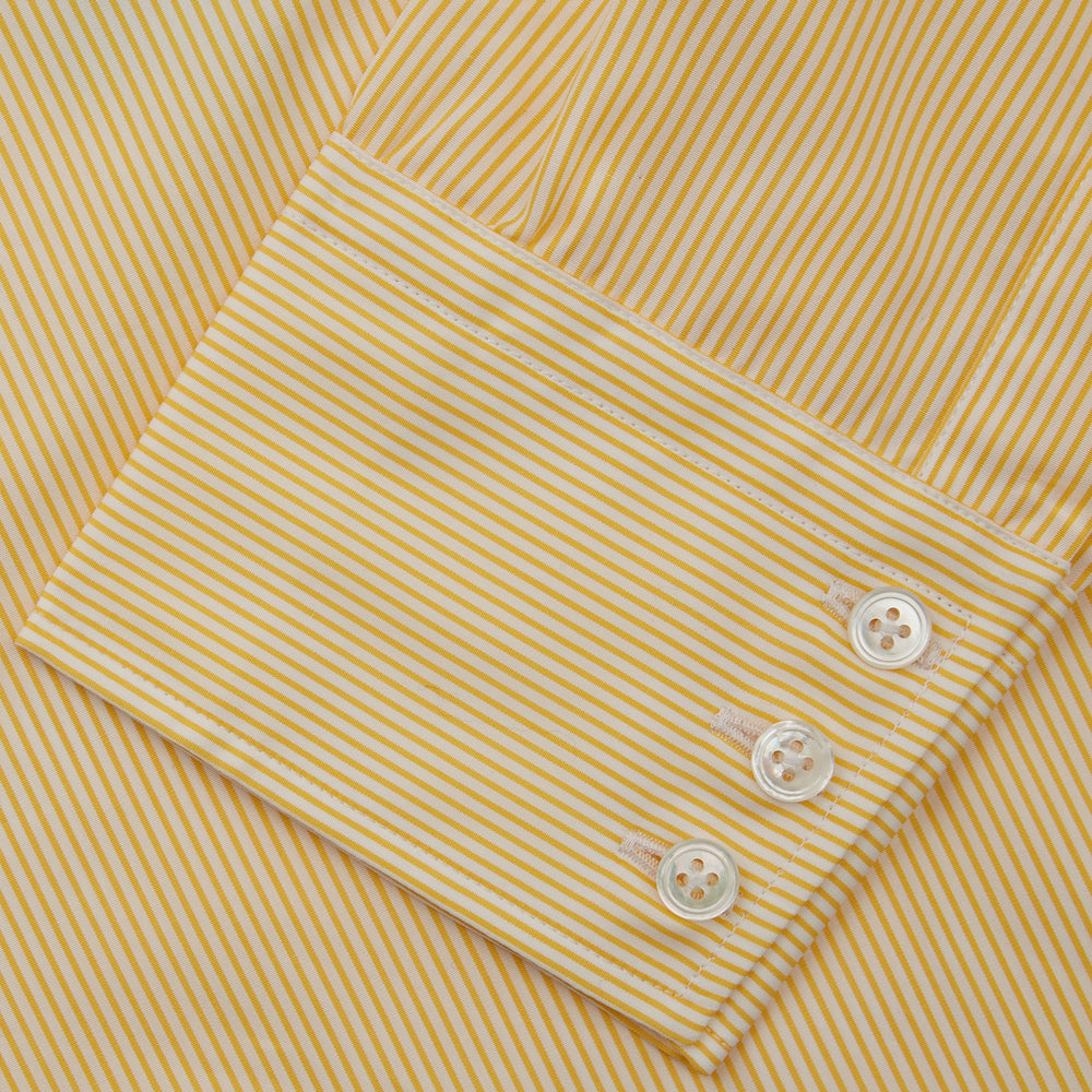 The Turnbull & Asser Yellow Fine Stripe Regular Fit Shirt with T&A Collar features long sleeves, a button-down front, and buttoned cuffs, crafted from fine Italian cotton and shown against a white background.
