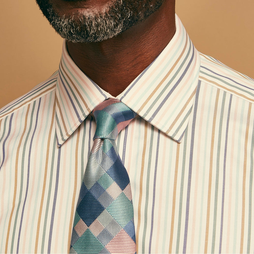 The Green Multi Pixel Silk Tie by Turnbull & Asser features a checked pattern in blue, teal, and pink on a light background, with diagonal stripes in each square for added texture.