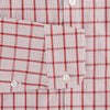 View 3 of product The Turnbull & Asser Red Graph Overlay Check Piccadilly Shirt is a cotton, long-sleeve button-up with a white base, red graph check pattern, collar, two chest flap pockets, and white buttons on the front and cuffs.