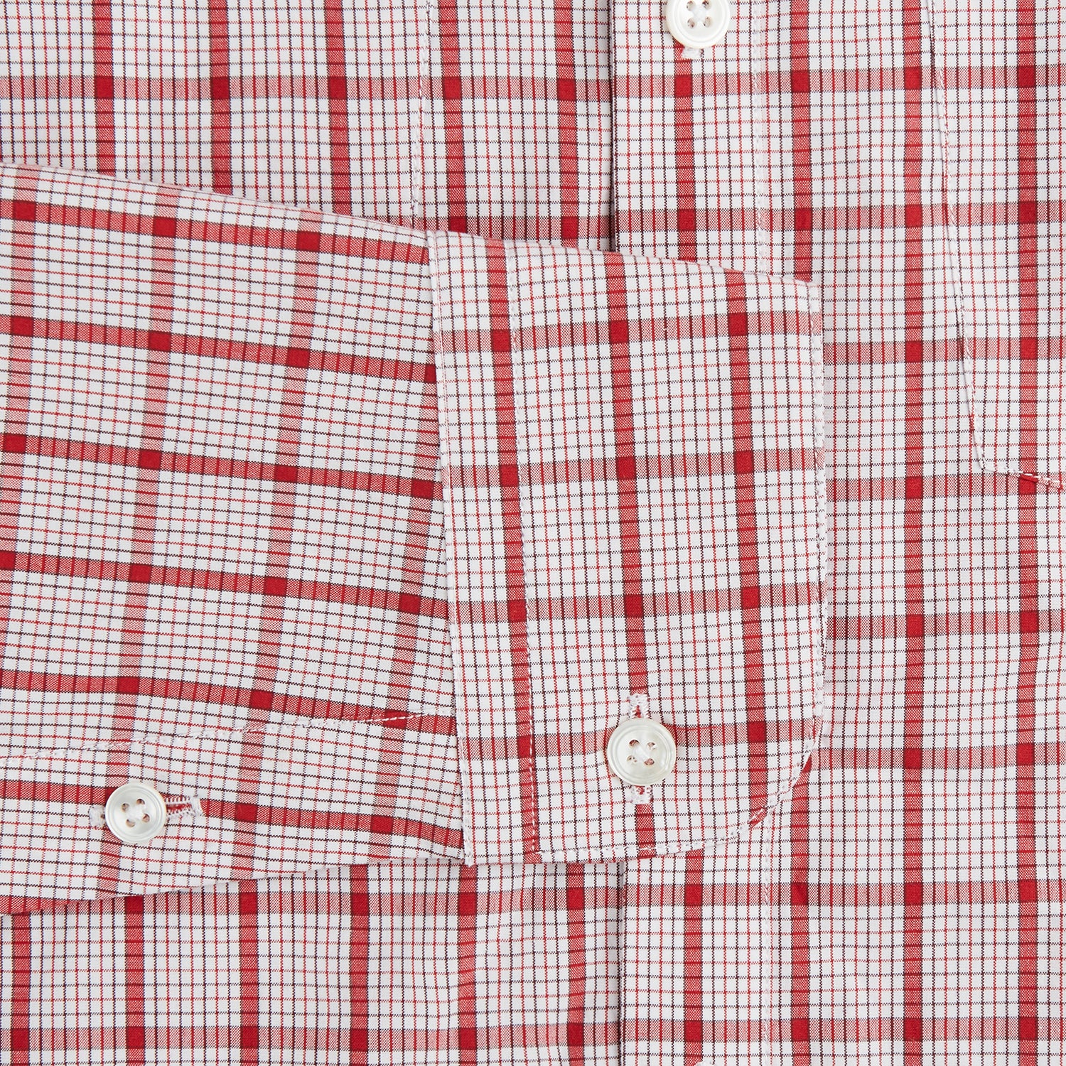 View 3 of product The Turnbull & Asser Red Graph Overlay Check Piccadilly Shirt is a cotton, long-sleeve button-up with a white base, red graph check pattern, collar, two chest flap pockets, and white buttons on the front and cuffs.