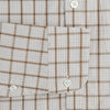 View 3 of product The Turnbull & Asser Brown Graph Overlay Check Piccadilly Shirt is a breathable cotton long-sleeve button-up with two chest pockets, in a beige and brown check pattern—ideal as your holiday fit shirt.