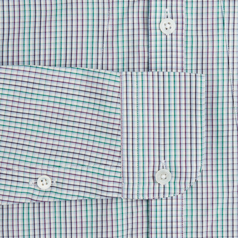 The Turnbull & Asser Green Graph Overlay Micro Check Piccadilly Shirt is a breathable cotton, long-sleeve button-up featuring a green micro check in light blue and white, two chest pockets with buttoned flaps, and white buttons.