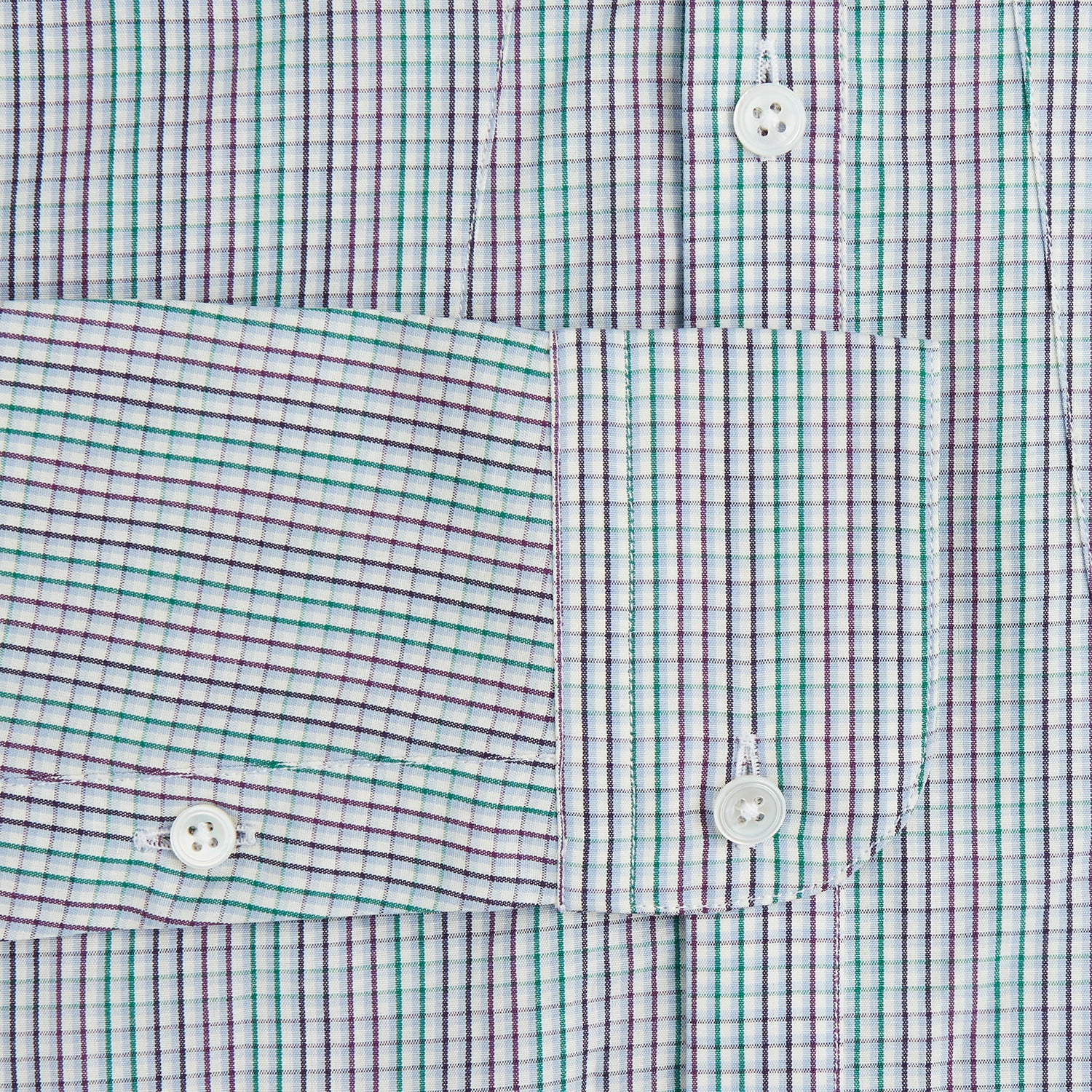 View 3 of product The Turnbull & Asser Green Graph Overlay Micro Check Piccadilly Shirt is a breathable cotton, long-sleeve button-up featuring a green micro check in light blue and white, two chest pockets with buttoned flaps, and white buttons.