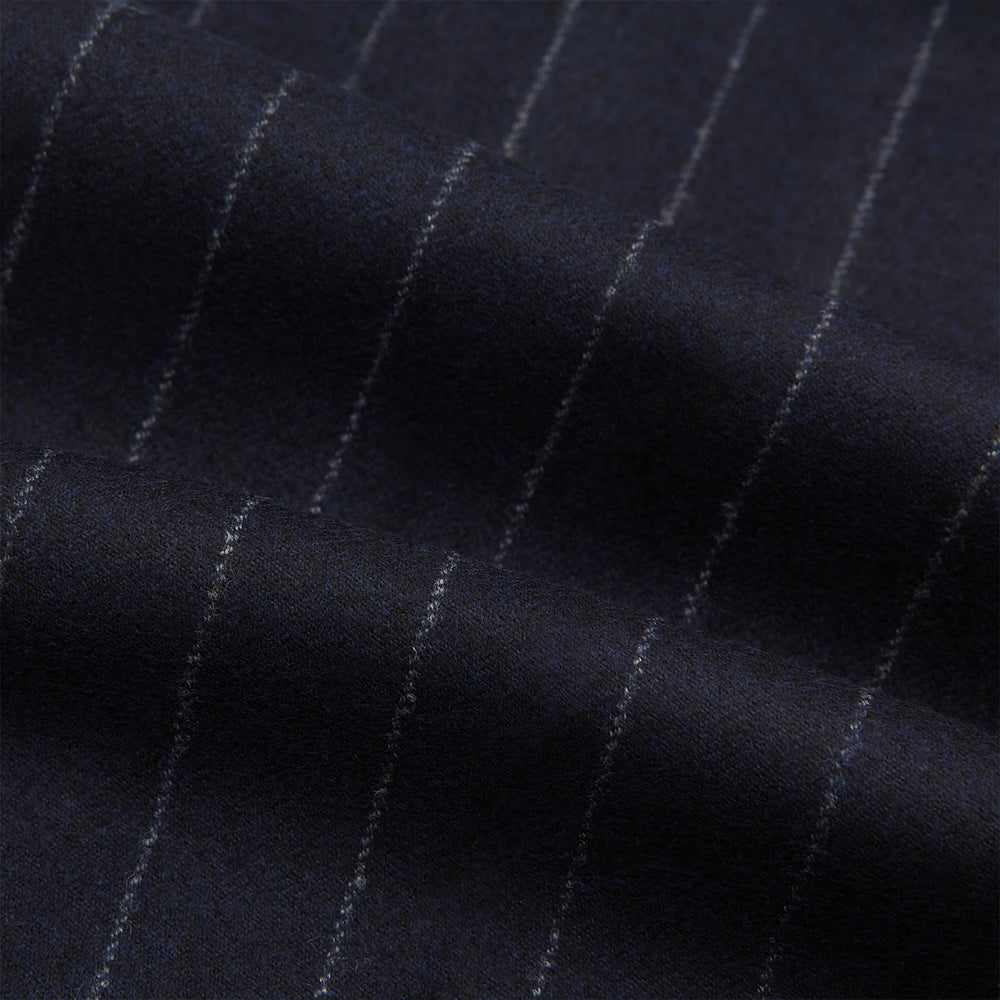 The Navy Pinstripe Henry Trousers by Turnbull & Asser feature vertical white stripes, a tailored fit, button closure, and belt loops. Crafted from a wool cashmere blend, they are shown against a plain white background.