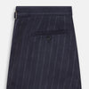 View 4 of product The Navy Pinstripe Henry Trousers by Turnbull & Asser feature vertical white stripes, a tailored fit, button closure, and belt loops. Crafted from a wool cashmere blend, they are shown against a plain white background.