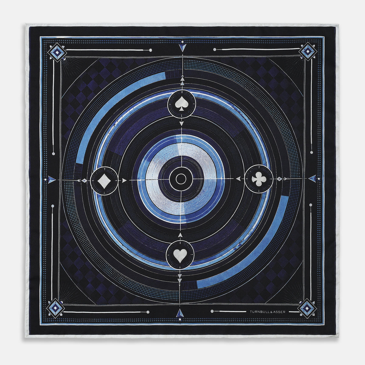 View 1 of product Presenting the Casino Royale Midnight Blue Target Pocket Square in Silk from Turnbull & Asser UK—a luxurious silk square scarf adorned with concentric circles in rich midnight blue and black, accented by playing card suit symbols (spade, diamond, club, heart) at each cardinal point and striking geometric patterns in the corners. This elegant accessory is perfect for adding a touch of sophisticated intrigue to your ensemble.