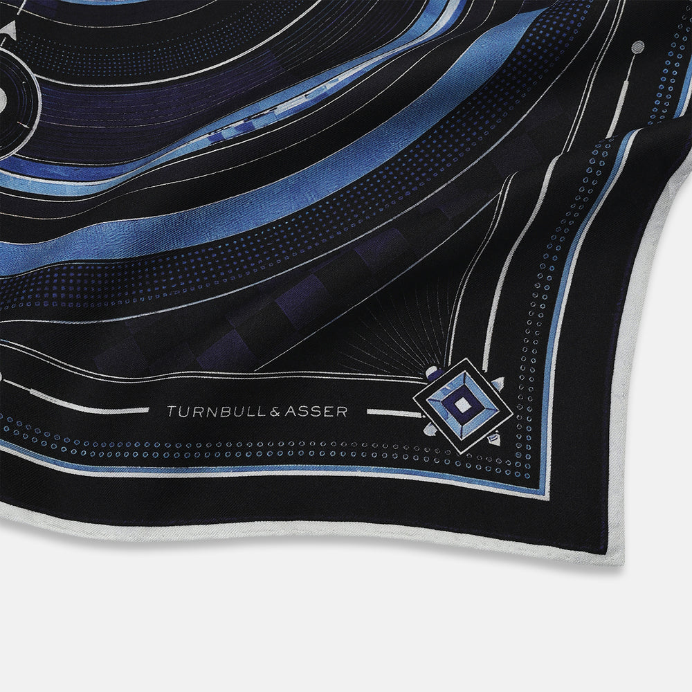 Presenting the Casino Royale Midnight Blue Target Pocket Square in Silk from Turnbull & Asser UK—a luxurious silk square scarf adorned with concentric circles in rich midnight blue and black, accented by playing card suit symbols (spade, diamond, club, heart) at each cardinal point and striking geometric patterns in the corners. This elegant accessory is perfect for adding a touch of sophisticated intrigue to your ensemble.