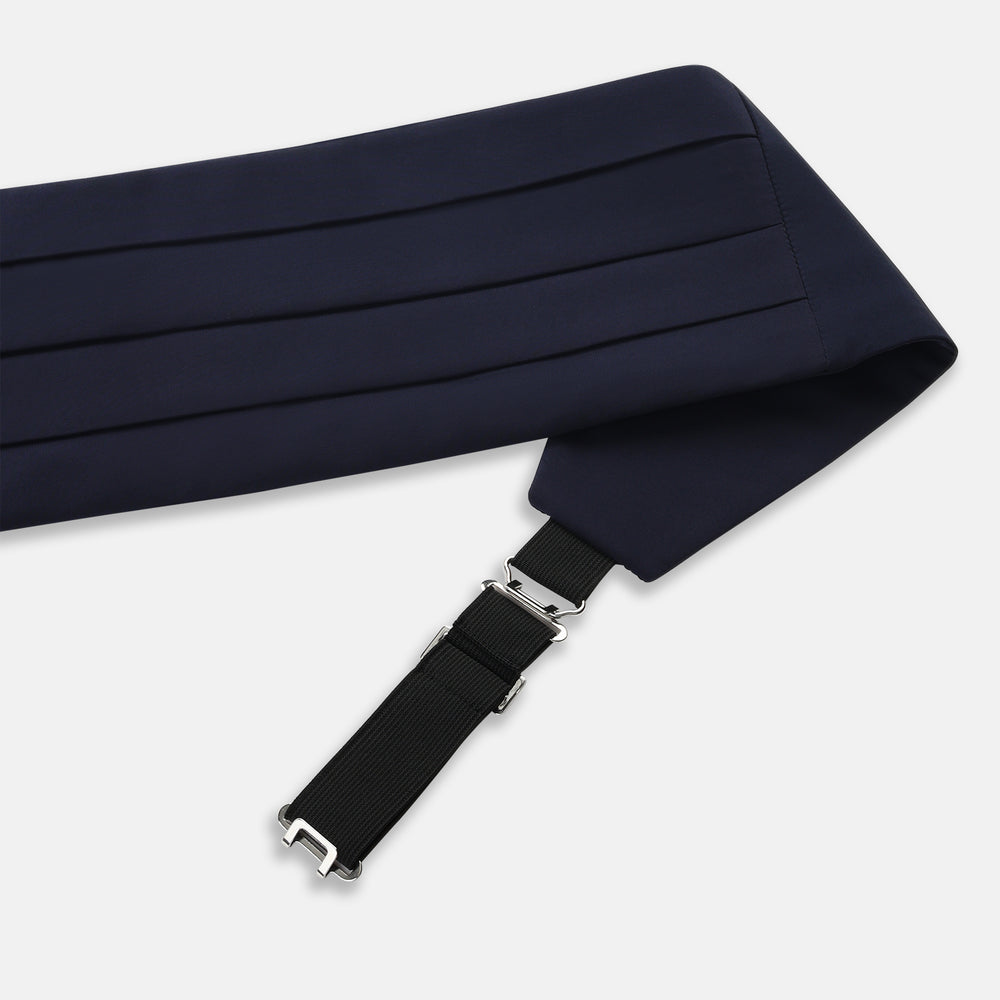 The Turnbull & Asser UK Casino Royale Midnight Blue Cummerbund in silk, featuring elegant horizontal pleats and showcased flat on a white background, is a sophisticated accessory crafted to enhance any formal evening attire.