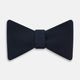 A classic Casino Royale Midnight Blue Bow Tie in silk by Turnbull & Asser UK, crafted from luxurious silk with a smooth texture, is neatly tied and displayed against a plain white background.