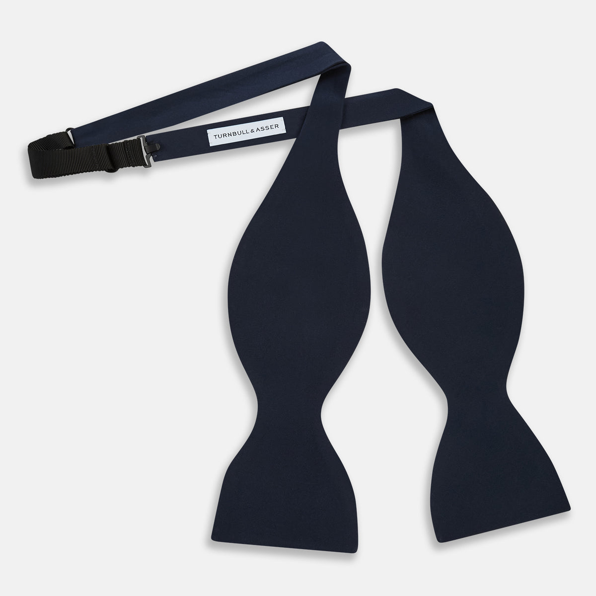 View 2 of product A classic Casino Royale Midnight Blue Bow Tie in silk by Turnbull & Asser UK, crafted from luxurious silk with a smooth texture, is neatly tied and displayed against a plain white background.