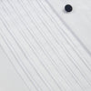 View 7 of product The Casino Royale White Dress Shirt in Cotton by Turnbull & Asser UK is a long-sleeve white dress shirt, crafted from crisp white cotton poplin with a pleated bib front, black buttons, and a classic collar, shown laid flat on a white background.