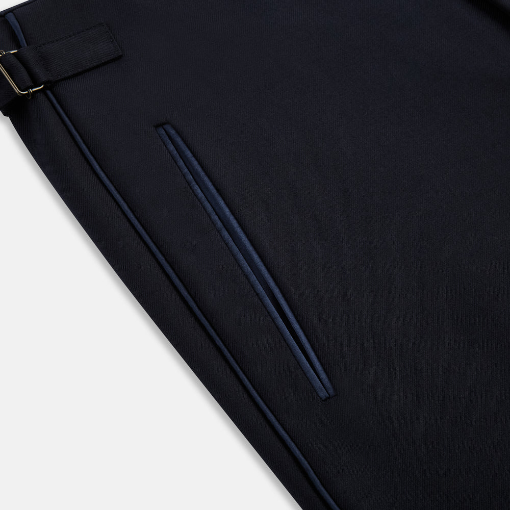 The Casino Royale Midnight Blue Tuxedo Trousers in Wool by Turnbull & Asser UK are shown from the back, expertly crafted from virgin wool in a signature tuxedo style, featuring two buttoned back pockets and adjustable side tabs at the waistband.