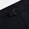 View 8 of product The Casino Royale Midnight Blue Tuxedo Trousers in Wool by Turnbull & Asser UK are shown from the back, expertly crafted from virgin wool in a signature tuxedo style, featuring two buttoned back pockets and adjustable side tabs at the waistband.