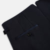 View 7 of product The Casino Royale Midnight Blue Tuxedo Trousers in Wool by Turnbull & Asser UK are shown from the back, expertly crafted from virgin wool in a signature tuxedo style, featuring two buttoned back pockets and adjustable side tabs at the waistband.