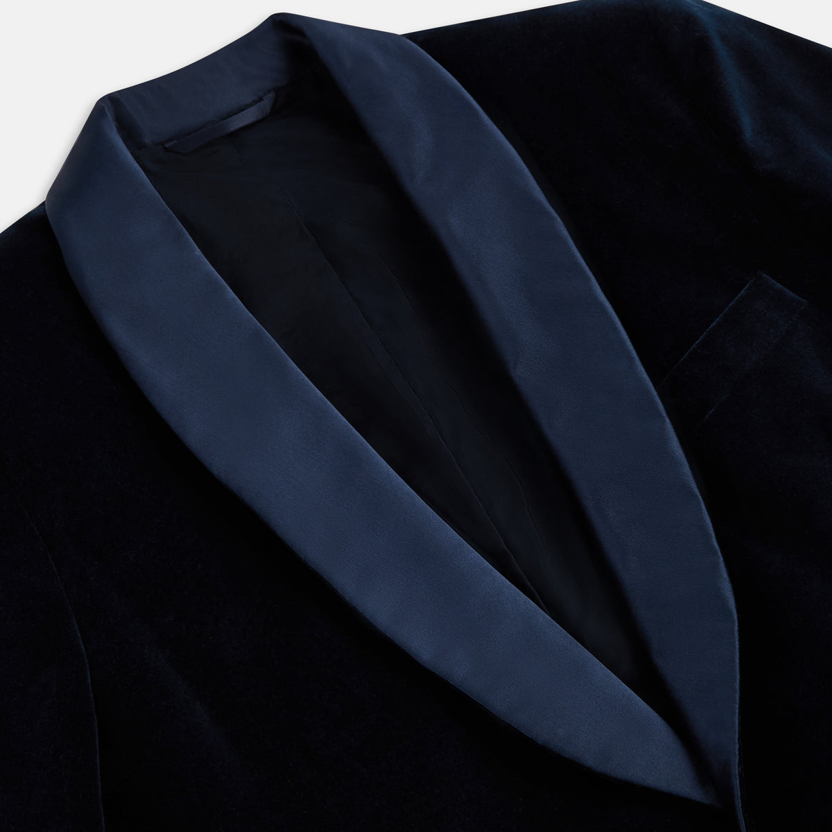 View 2 of product Turnbull & Asser UK’s Casino Royale Midnight Blue Tuxedo Jacket in Cotton Velvet, featuring a single button closure and a luxurious silk-satin shawl lapel, is showcased against a plain white background.