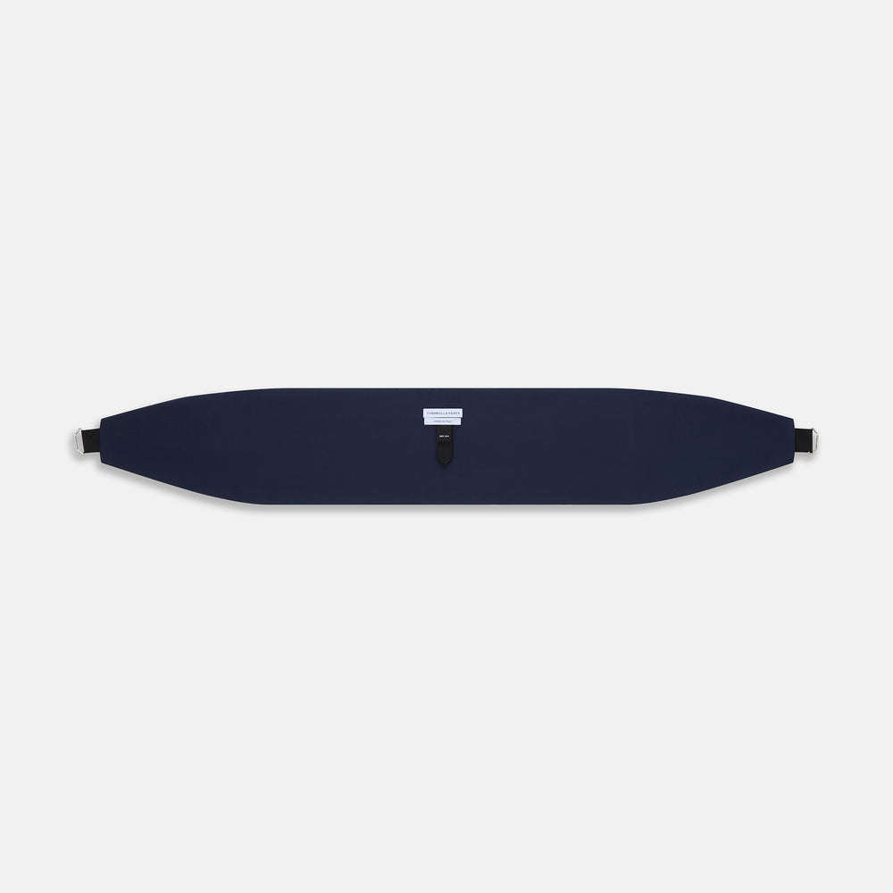 The Turnbull & Asser UK Casino Royale Midnight Blue Cummerbund in silk, featuring elegant horizontal pleats and showcased flat on a white background, is a sophisticated accessory crafted to enhance any formal evening attire.