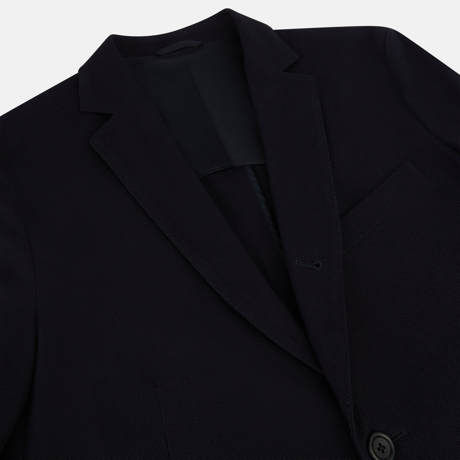 View 2 of product The Navy Knitted London Blazer by Turnbull & Asser features notch lapels, two buttons, and three front pockets—ideal for spring or summer contemporary looks. Displayed on a plain white background.
