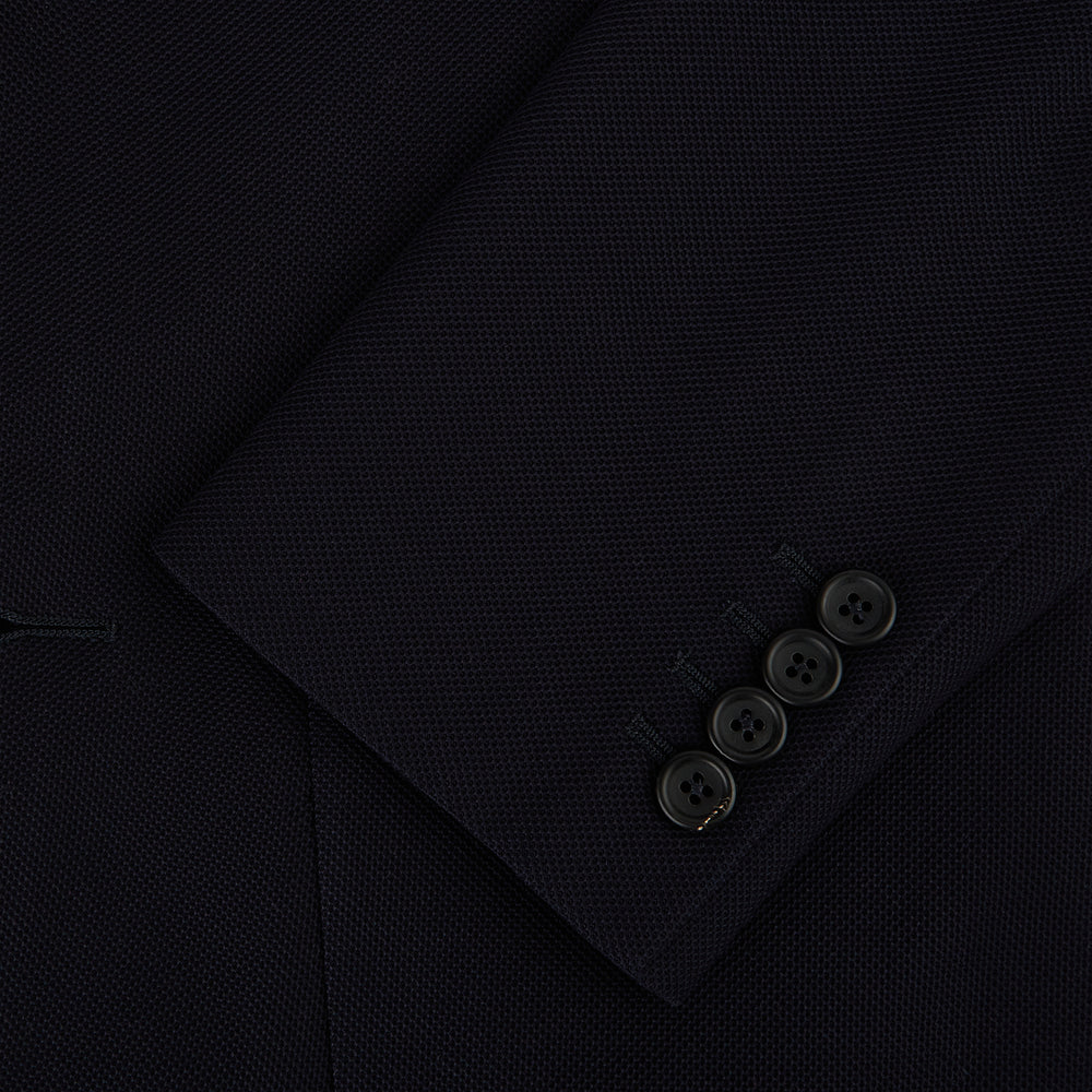 The Navy Knitted London Blazer by Turnbull & Asser features notch lapels, two buttons, and three front pockets—ideal for spring or summer contemporary looks. Displayed on a plain white background.